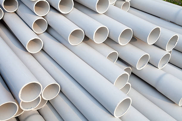 Heap of PVC pipes stacked at construction site, Close-up.